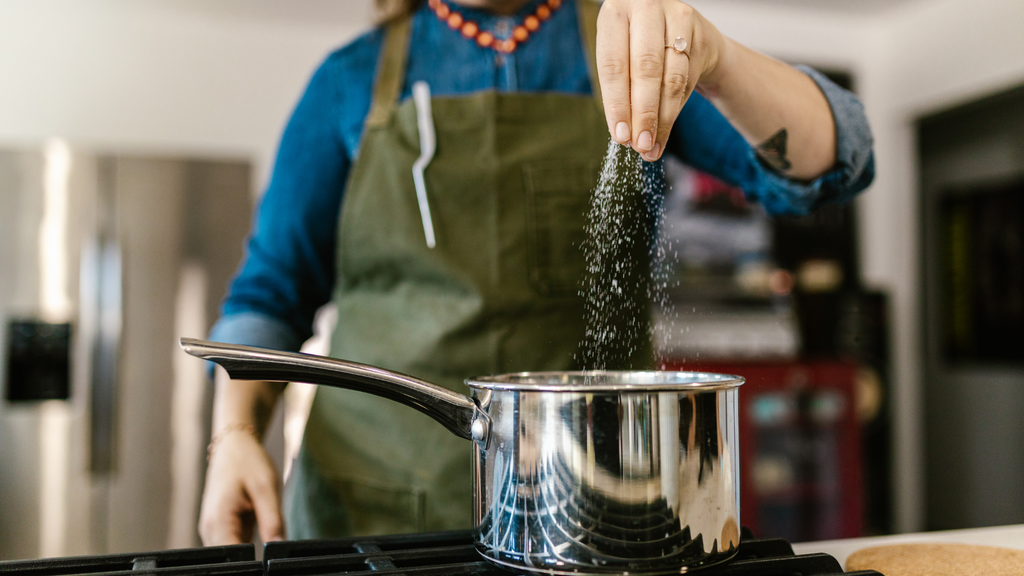 using a pinch of salt to season food which helps gets sodium in your system