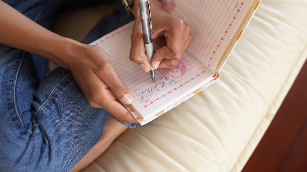 Person sitting down in the morning to journal