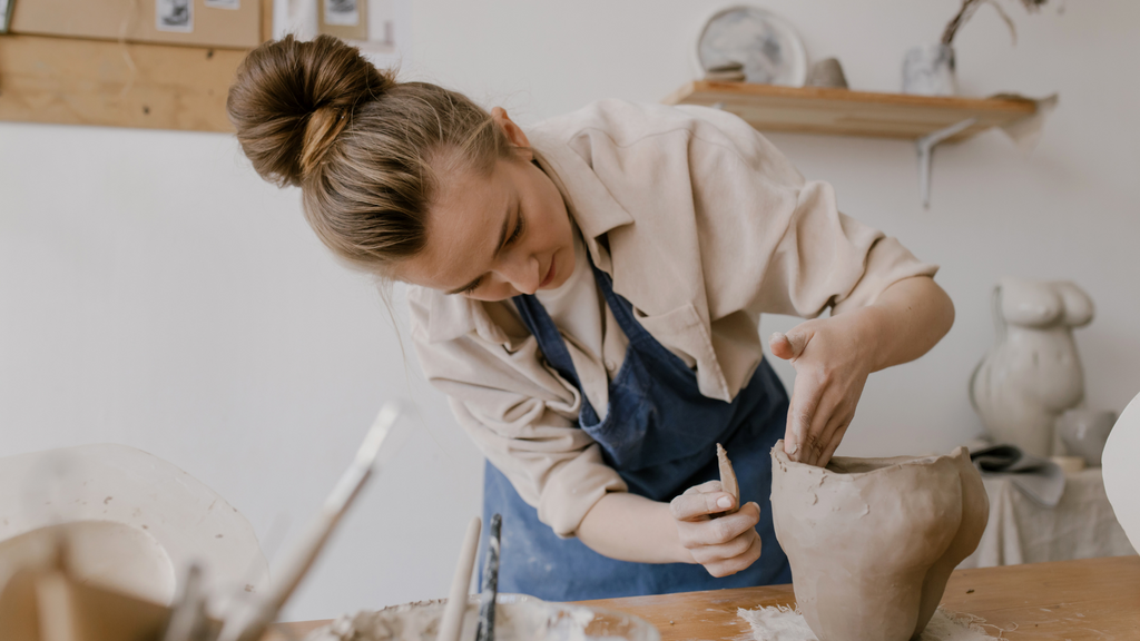 Woman using pottery as a way to cope with stress - she found her hobby and so can you