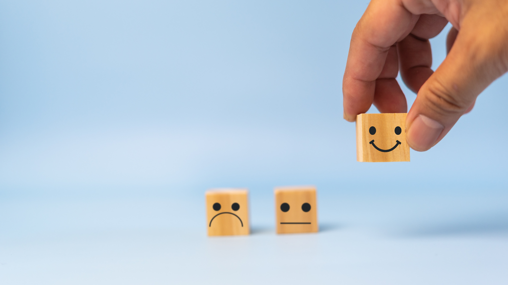 A sad block, indifferent block, and smiley block