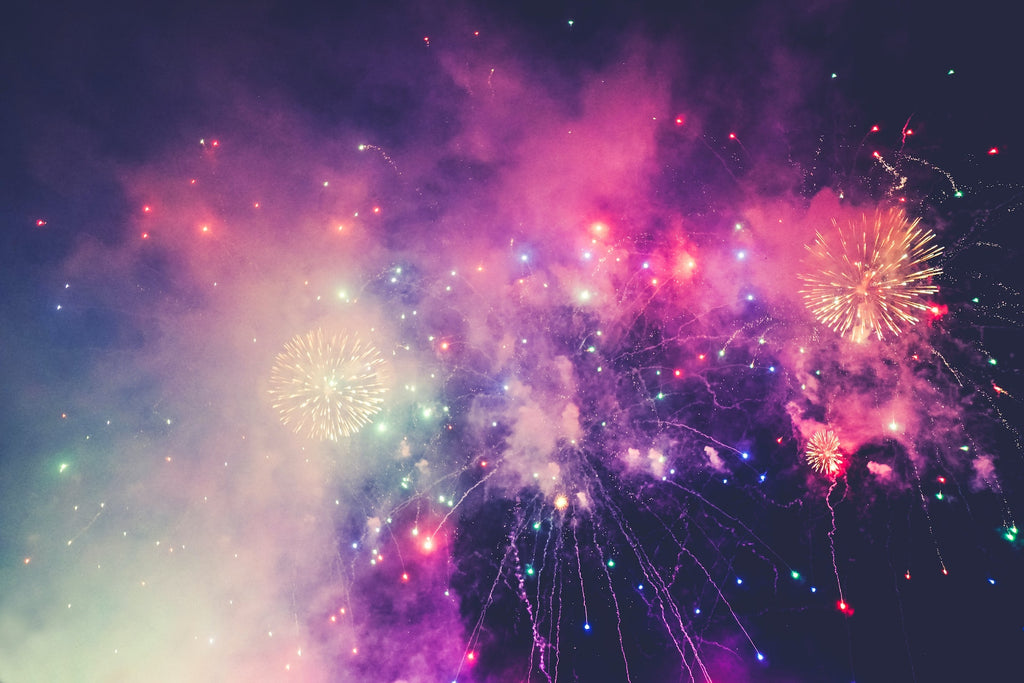 Fireworks of every color and smoke and pollution in the night sky